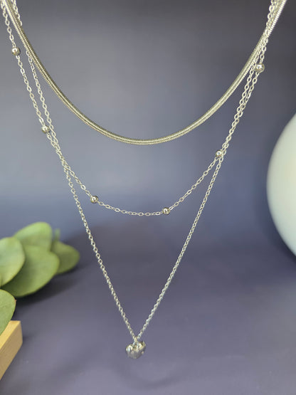 The Siren Serenity silver trio shown floating to highlight the three separate chains. Tarnish-resistant snake, satellite, and heart necklaces - My Silver Lining.