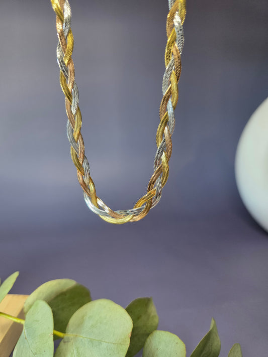 Trinity Braid necklace showcasing the intricate weave of gold, silver, and rose gold strands. This waterproof tri-tone stainless steel chain offers a multi-dimensional shimmer - My Silver Lining.