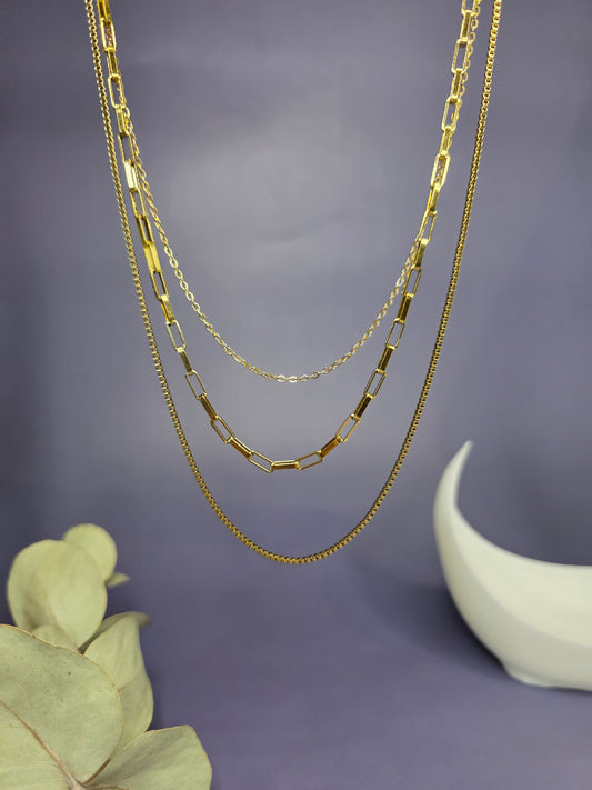 Close-up of the Trinity Golden Layer necklace hanging, highlighting the three unique chain textures and high-shine golden finish — My Silver Lining.