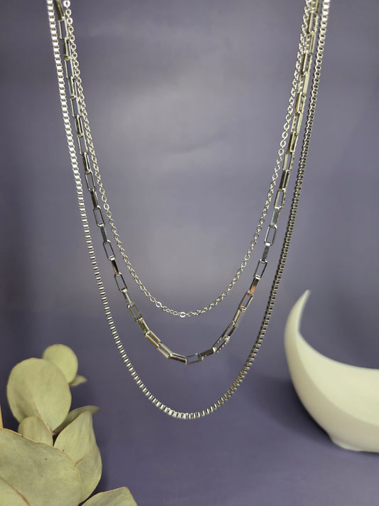 Optimized close-up of the Trinity Silver Layer necklace hanging, highlighting the three unique chain textures and high-shine silver finish — My Silver Lining.