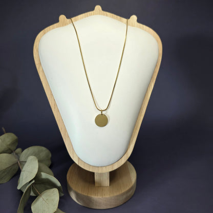 Front view of the Golden Mamma Bear necklace on a jewelry bust, showcasing the full variant with no smaller discs — My Silver Lining.
