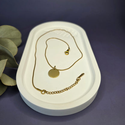 Close-up of the Golden Mamma Bear necklace on a white oval tray, highlighting the 0.9mm snake chain and adjustable extender — My Silver Lining.