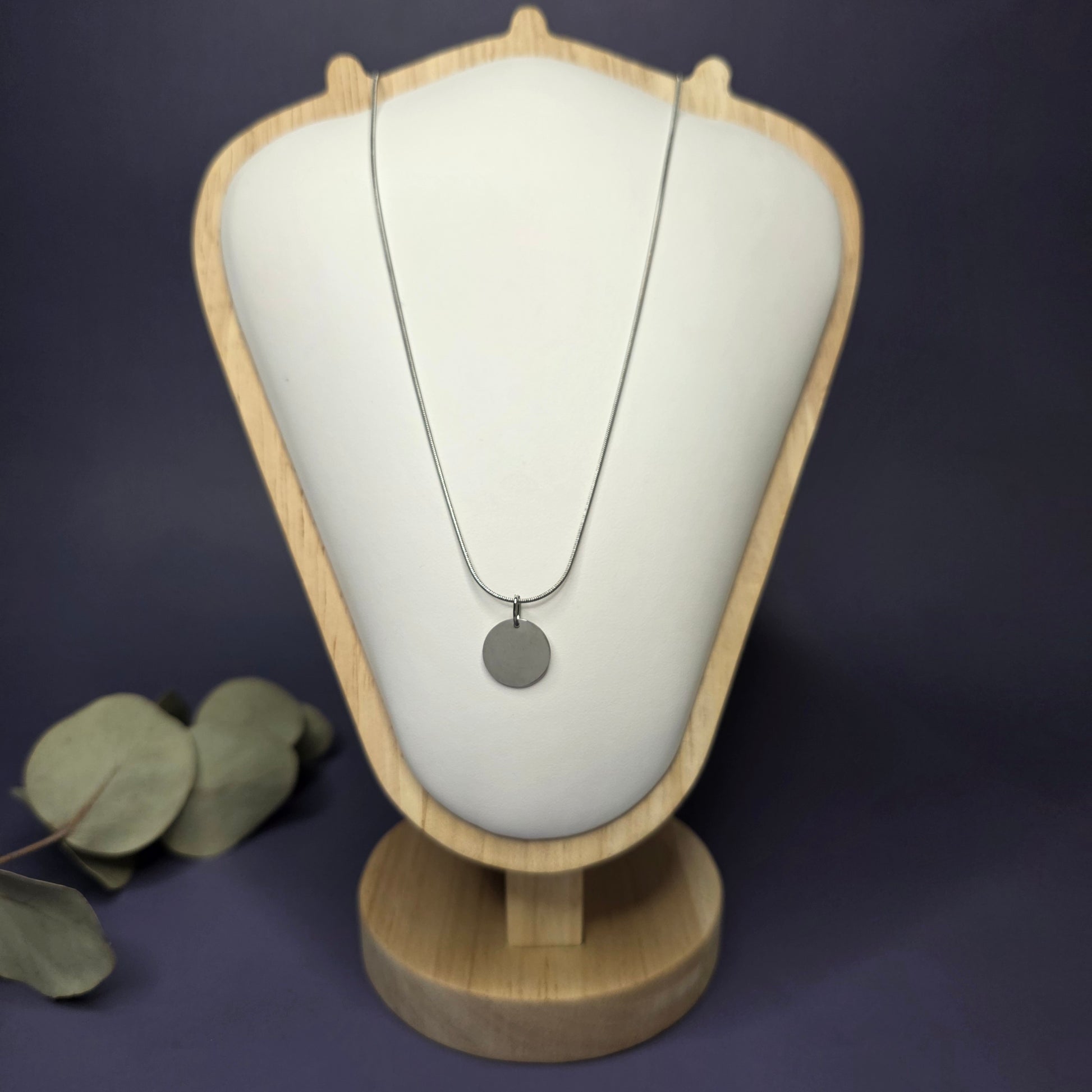 Front view of the Silver Mamma Bear necklace on a jewelry bust, showcasing the full variant with no smaller discs — My Silver Lining.