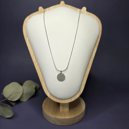 Front view of the Silver Mamma Bear necklace on a jewelry bust, showcasing the full variant with no smaller discs — My Silver Lining.