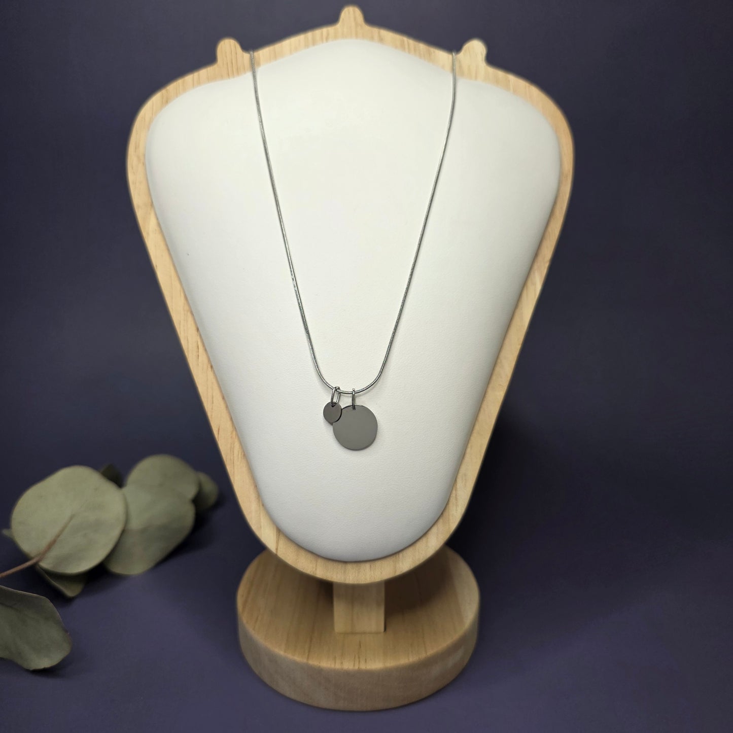 Front view of the Siler Mamma Bear necklace on a jewelry bust, showcasing the full variant with one smaller discs — My Silver Lining.