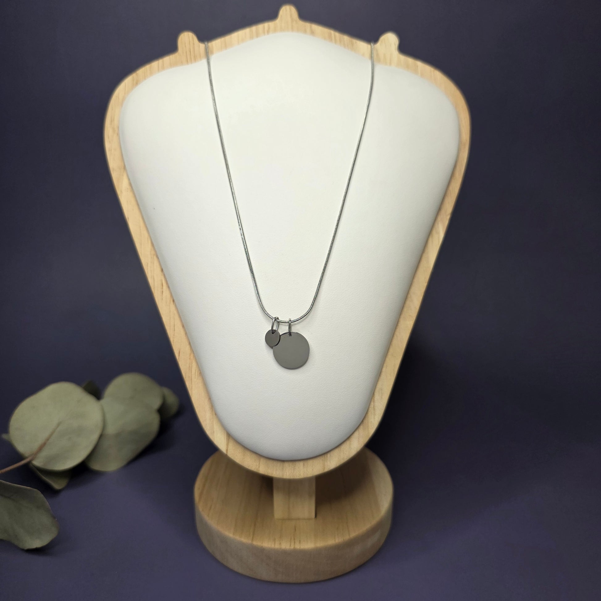 Front view of the Siler Mamma Bear necklace on a jewelry bust, showcasing the full variant with one smaller discs — My Silver Lining.