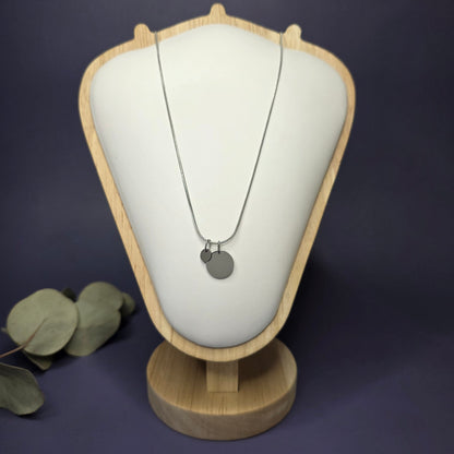 Front view of the Siler Mamma Bear necklace on a jewelry bust, showcasing the full variant with one smaller discs — My Silver Lining.