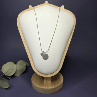 Front view of the Siler Mamma Bear necklace on a jewelry bust, showcasing the full variant with two smaller discs — My Silver Lining.