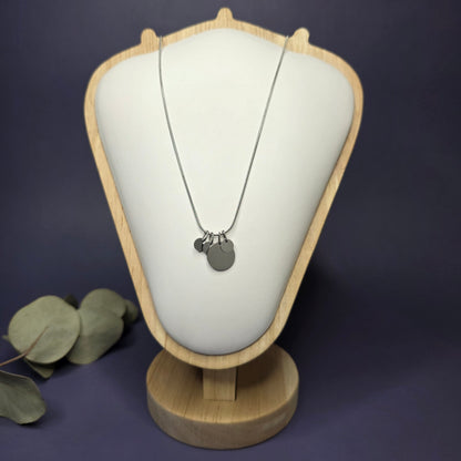 Front view of the Siler Mamma Bear necklace on a jewelry bust, showcasing the full variant with three smaller discs — My Silver Lining.