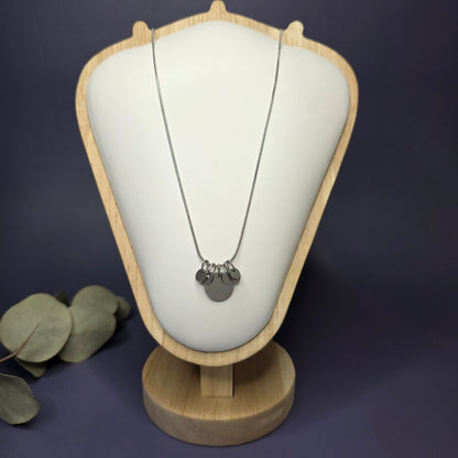 Front view of the Siler Mamma Bear necklace on a jewelry bust, showcasing the full variant with four smaller discs — My Silver Lining.