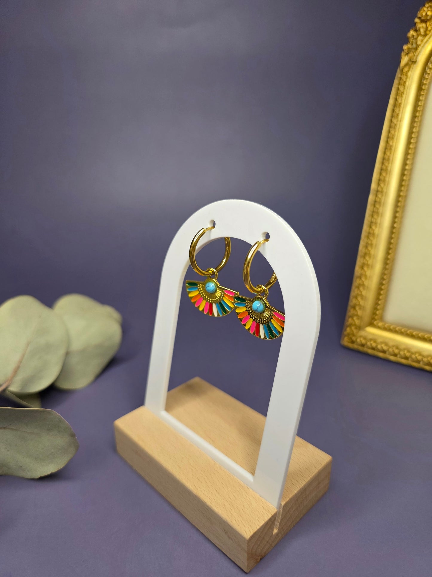 Side profile of Vivid Fan Gold Hoops on a white arch display, highlighting the secure hoop closure and vibrant charm — My Silver Lining.