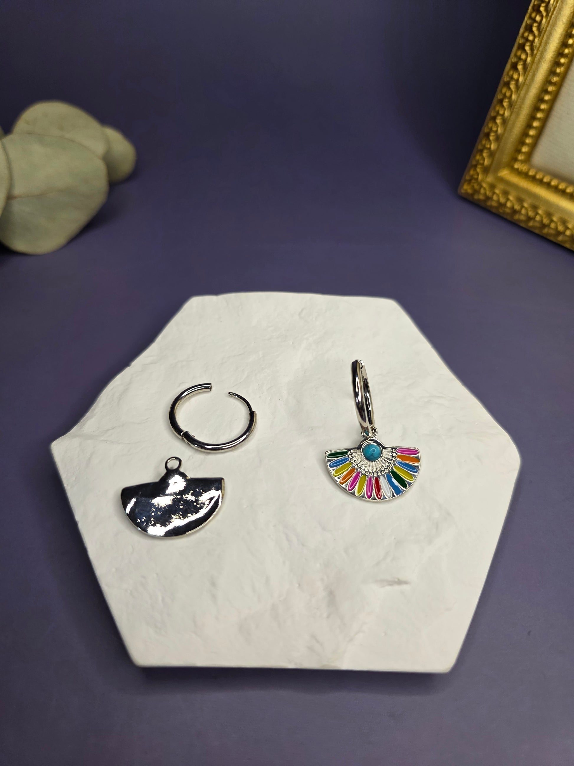 Vivid Fan Silver Hoops shown on a white hexagon stone, demonstrating the removable fan charm and the standalone silver hoop — My Silver Lining.