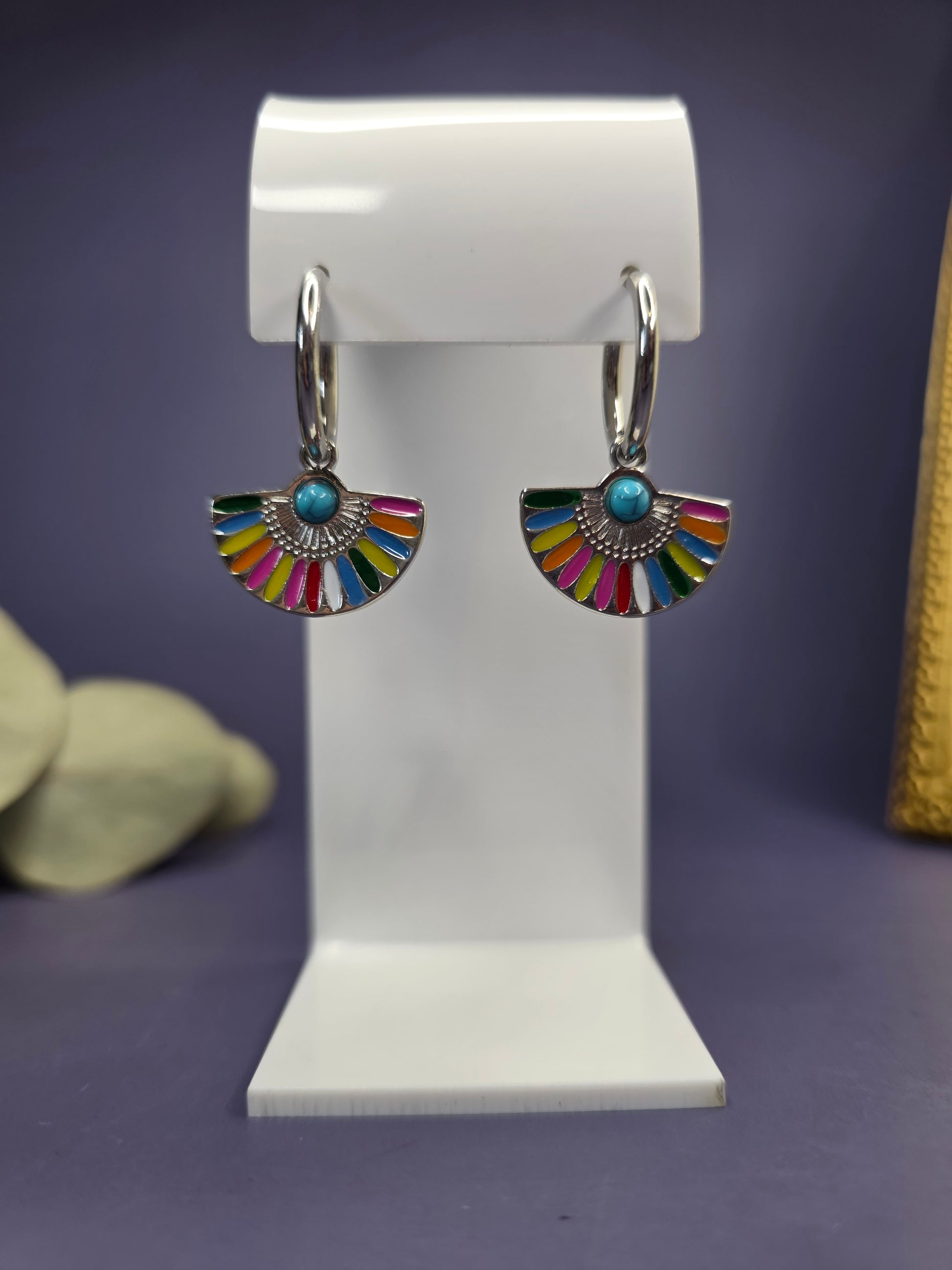 Front-facing view of the Vivid Fan Silver Hoops on a white display stand. Silver stainless steel hoops with colorful resin and turquoise-style inlay — My Silver Lining.