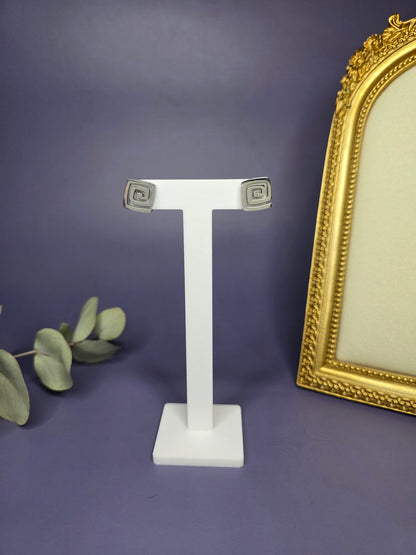 Vortex Silver Studs featuring a modern square spiral motif on a white T-stand. Crafted from waterproof 304L stainless steel for a durable, high-shine finish - My Silver Lining.